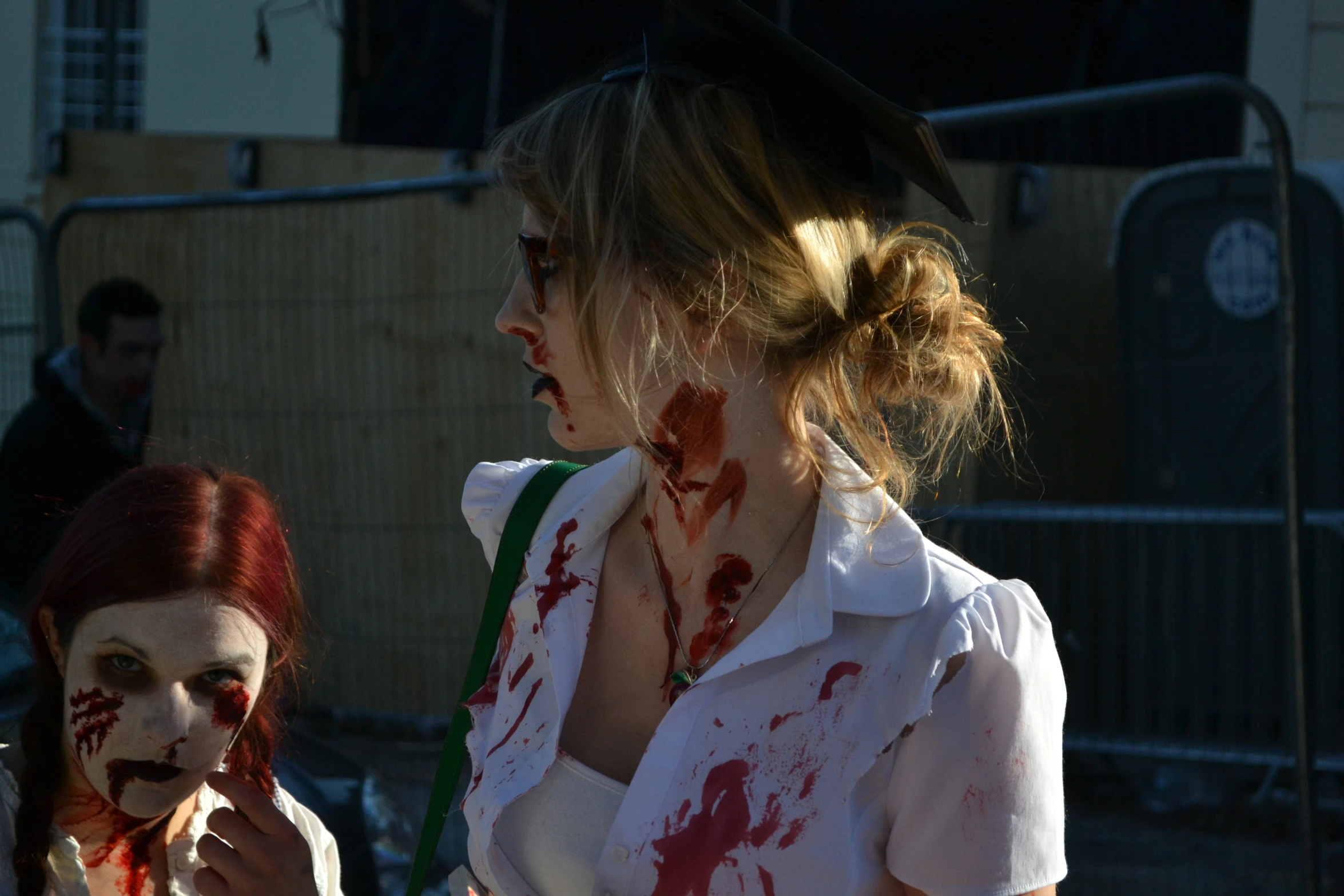 a woman in a zombie costume next to a zombie lady