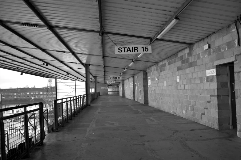 a brick walkway leading to the entrance to an industrial building