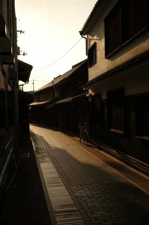 an alleyway with a bicycle on the other side of it