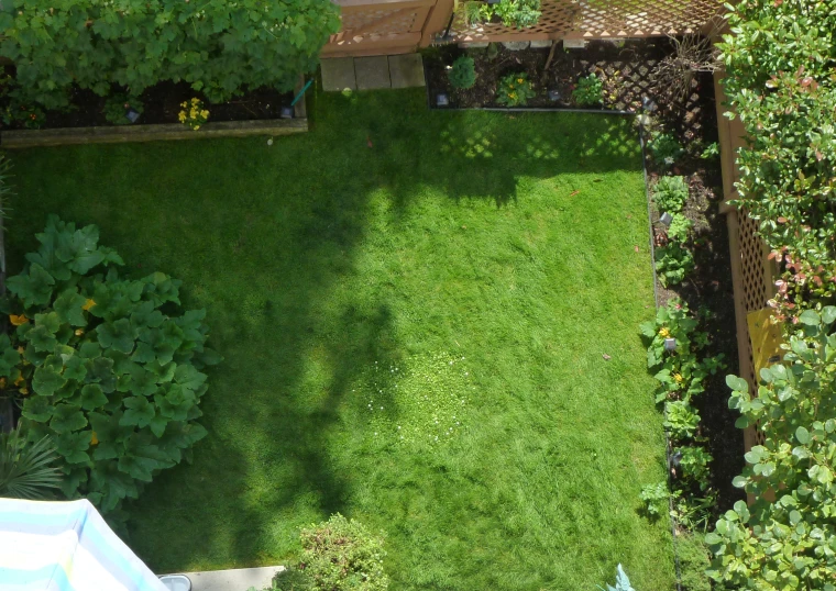 a grassy yard with lawn furniture and a fenced in back yard