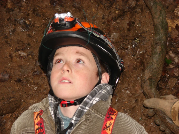 a boy wearing a helmet and safety equipment