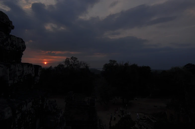 the sun is setting over a large park