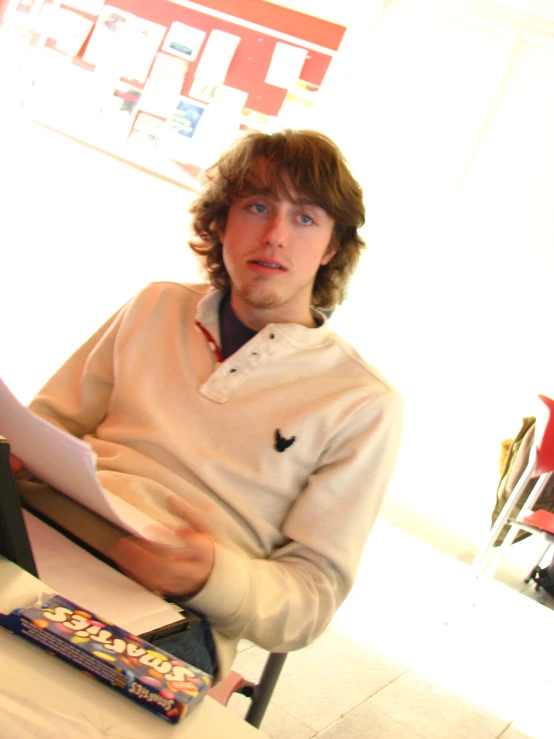 a man is sitting down with a book