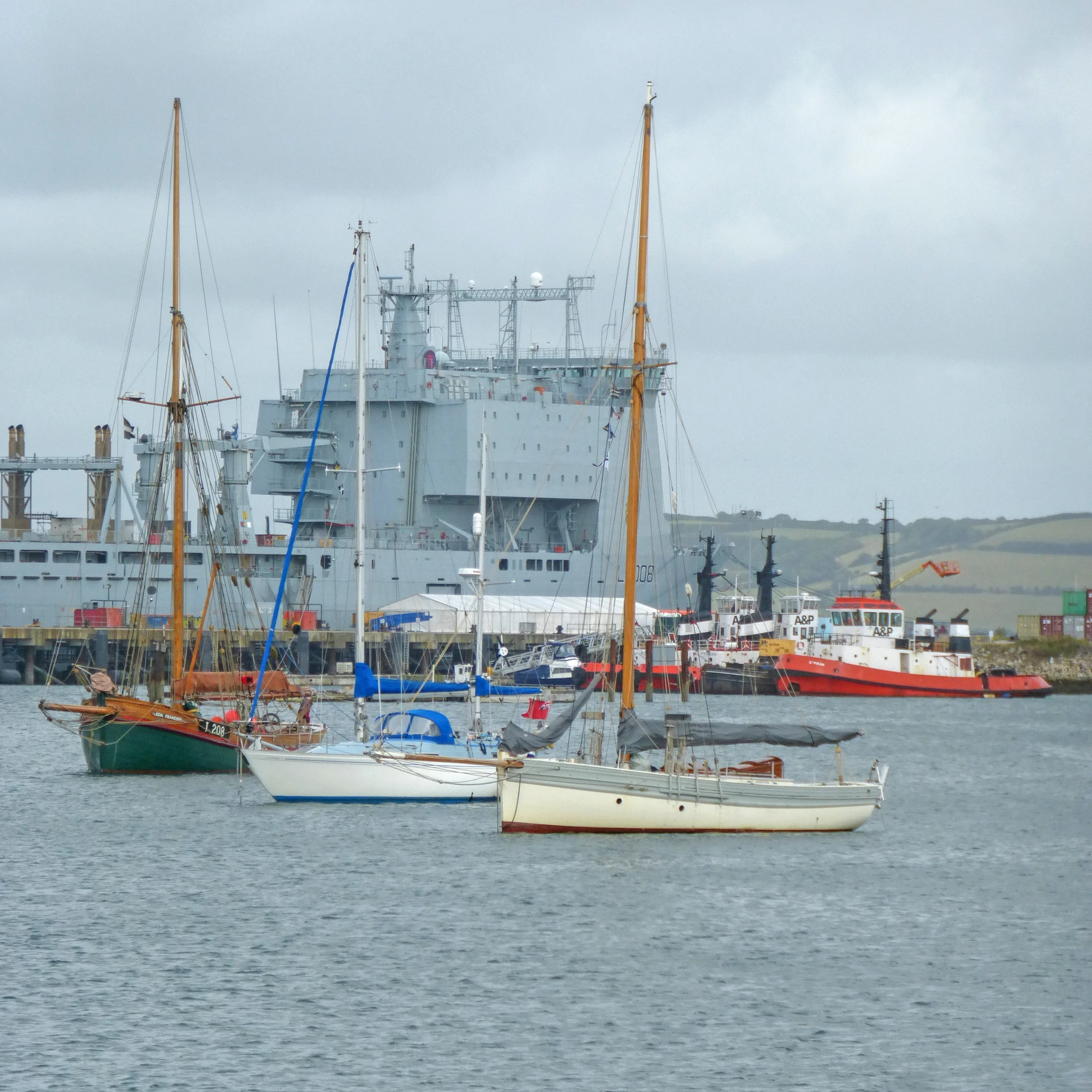 a group of ships sitting next to each other in the water