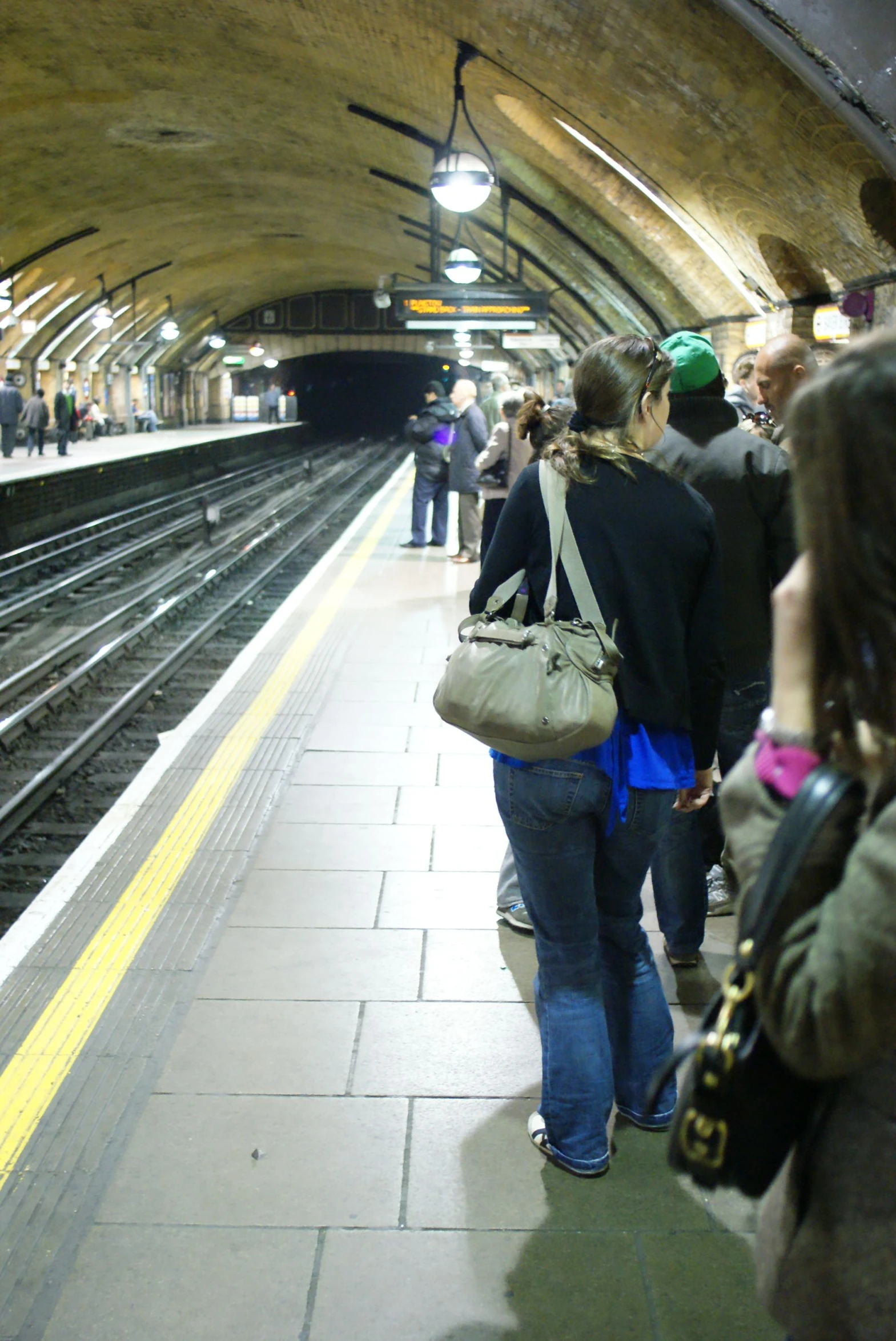 two women are standing at the train station