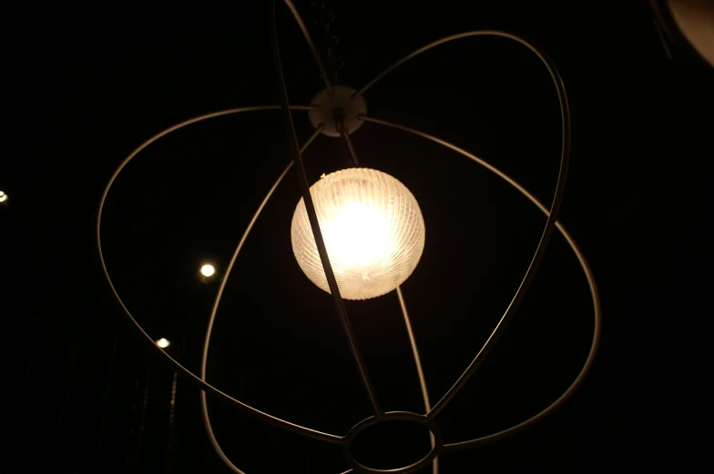 a light fixture hanging in the air at night