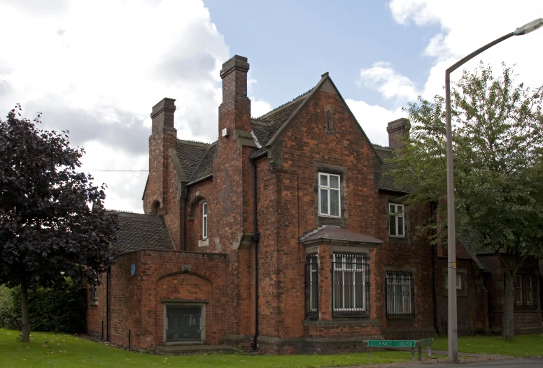 a building with windows and chimneys, on an almost empty road