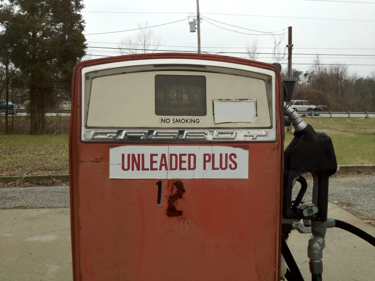 an old gas pump and hose on the side of the road