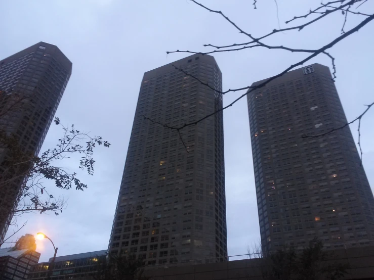 three high rise buildings on a cloudy, cloudy day