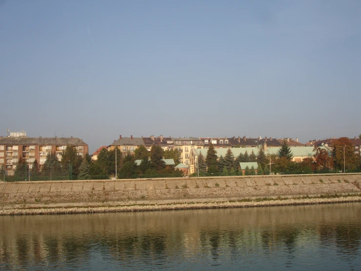 a body of water with buildings behind it