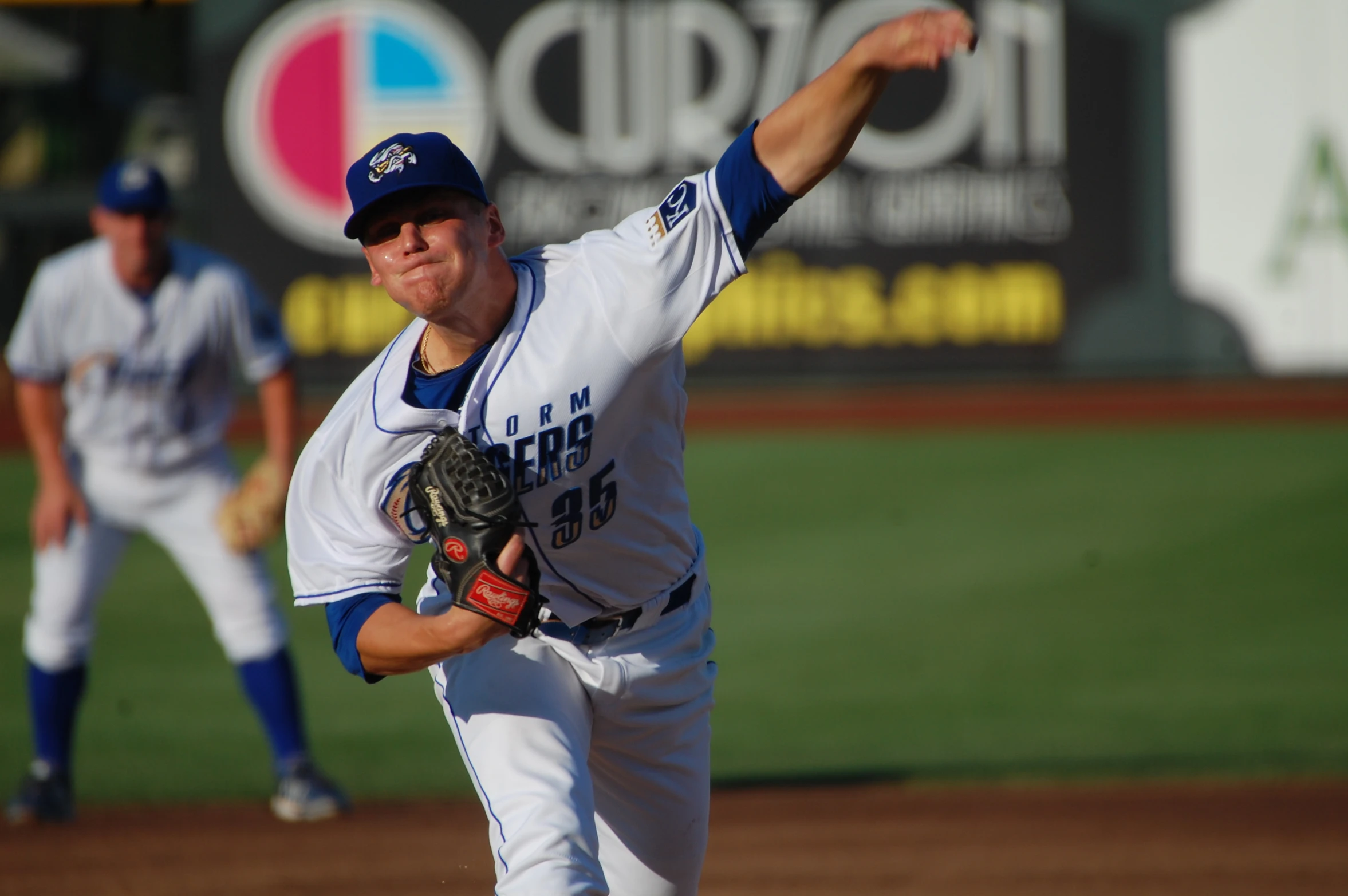 there is a male baseball player pitching a ball