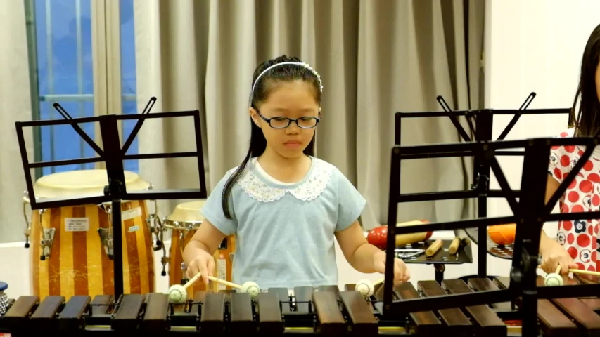 two girls in a room playing with musical instruments