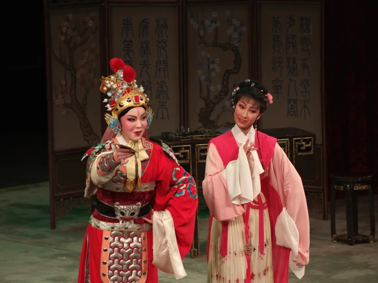 the two performers in the chinese opera show are dressed in period costumes