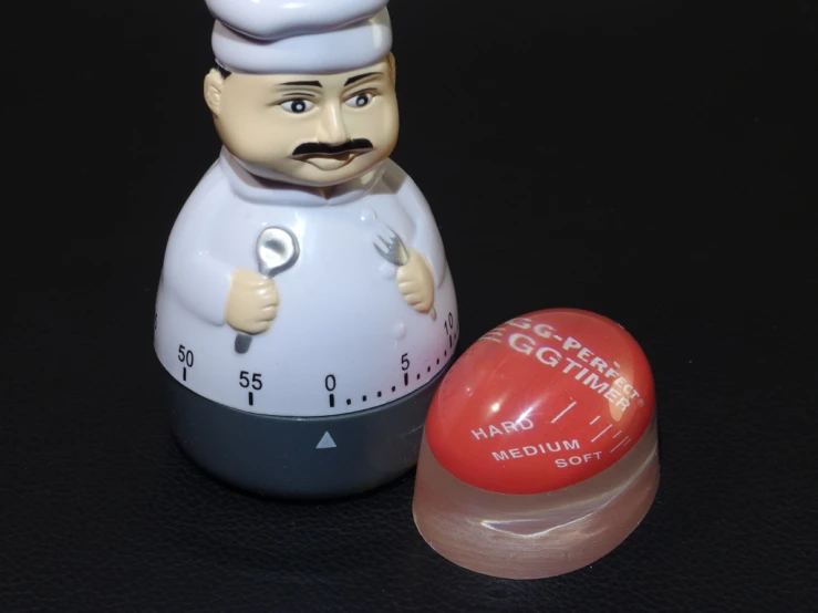 a salt and pepper shaker sitting next to an egg