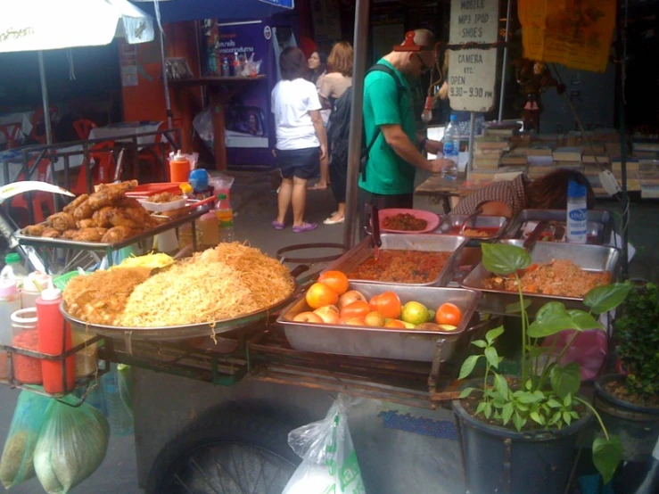 a group of people looking over different foods