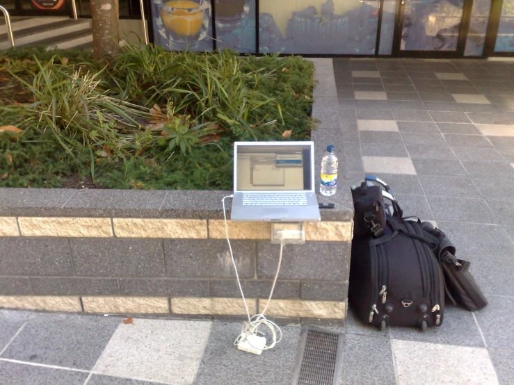 a laptop and a backpack on some steps