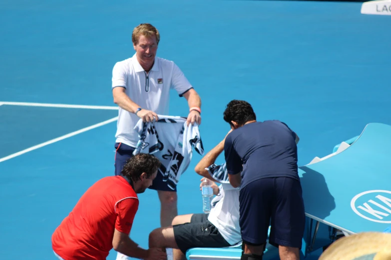 two tennis players getting their bags packed and ready for the game