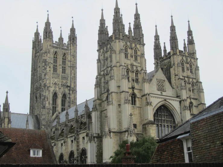 the top of two tall gothic structures in a city