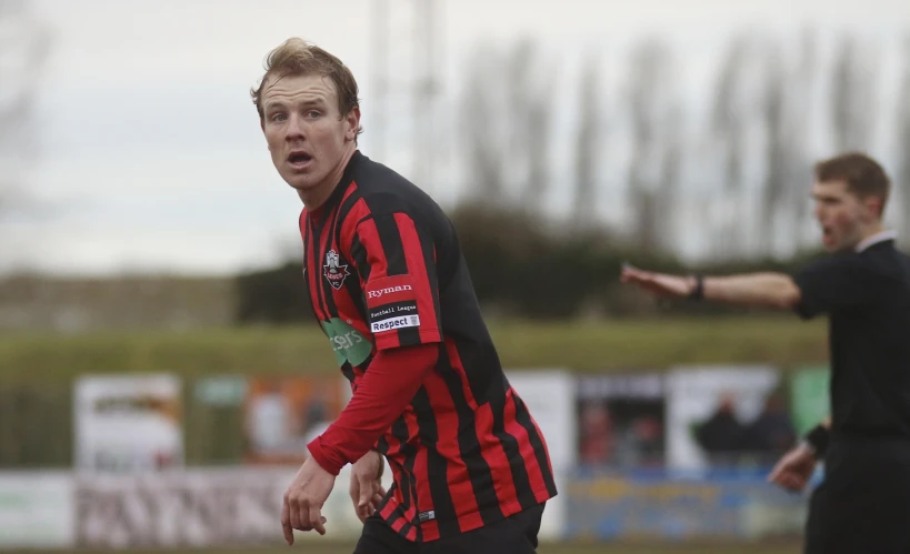 a referee in the middle of a game of soccer