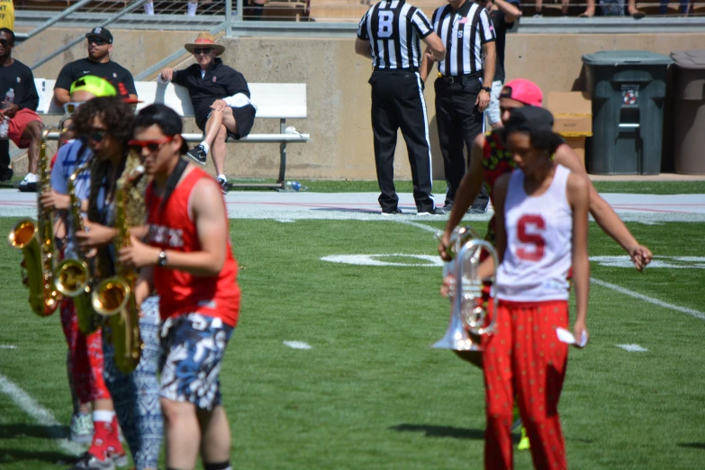 several people are on the field playing trombone