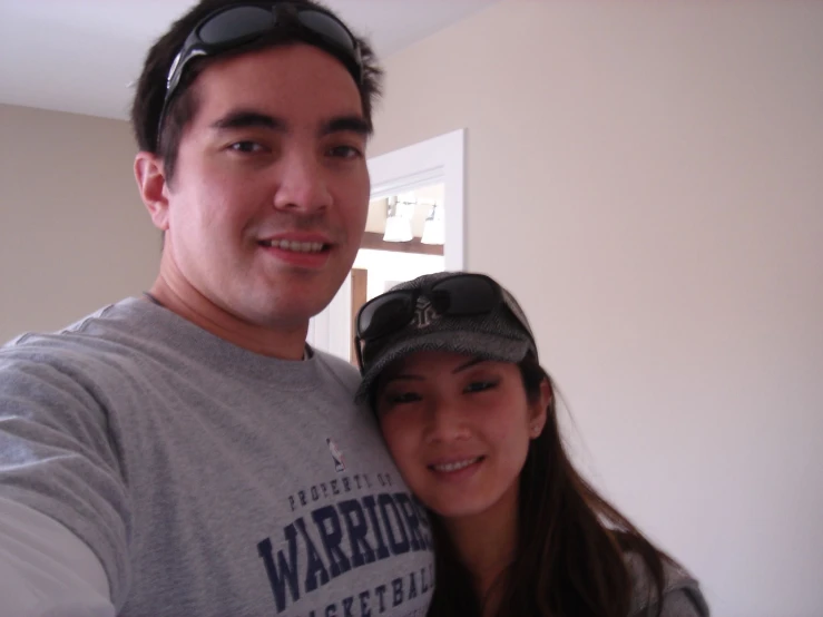 a man standing next to a woman in a bedroom