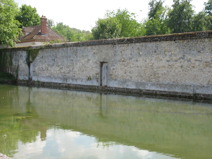 a water channel has many small, old buildings on the side of it