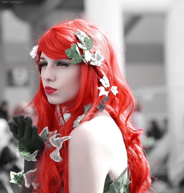 a woman wearing red and green hair is posing for a po