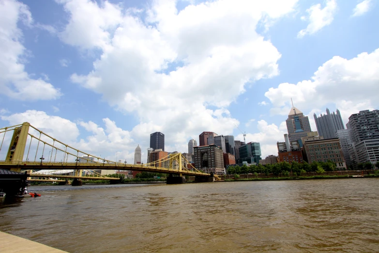 a bridge is in the foreground with a few skyscrs