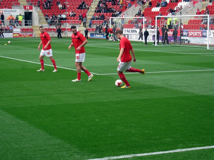 a group of young men play soccer on a field