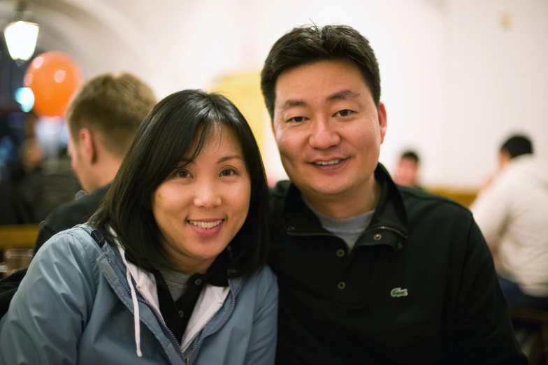 a man and woman that are smiling for the camera