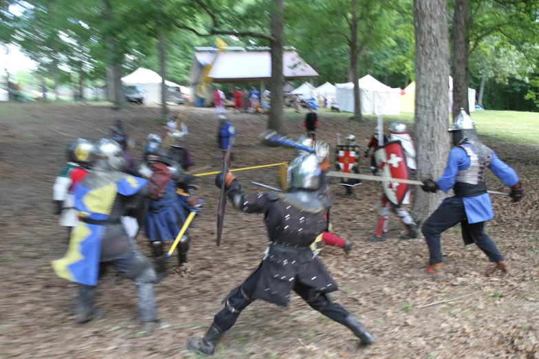 a group of people in costumes and helmets on playing with swords