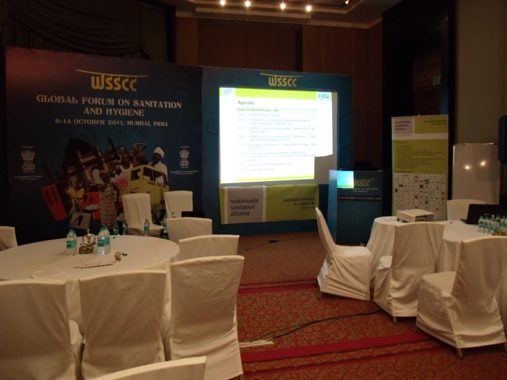 table covered with white linens during a conference