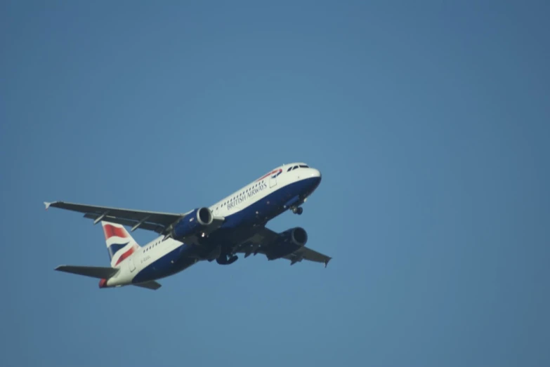 a commercial passenger plane flying overhead in a blue sky