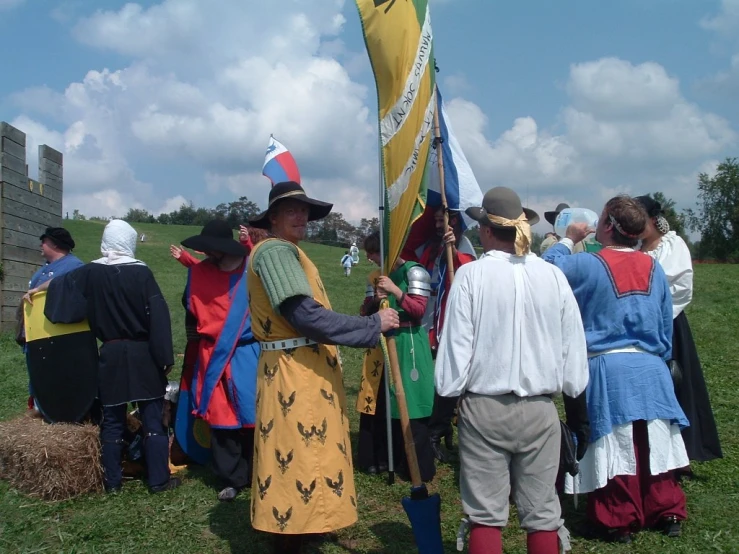 a group of people dressed in costumes holding a flag