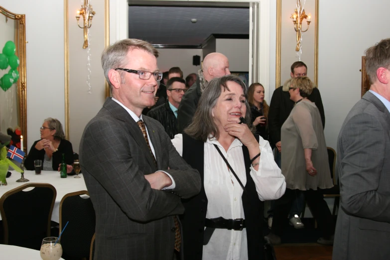 a man and woman standing together smiling