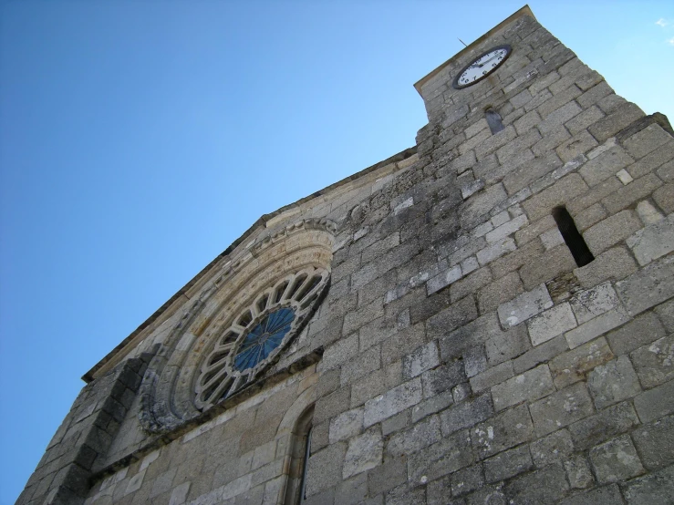 an old church has large windows with blue and white markings