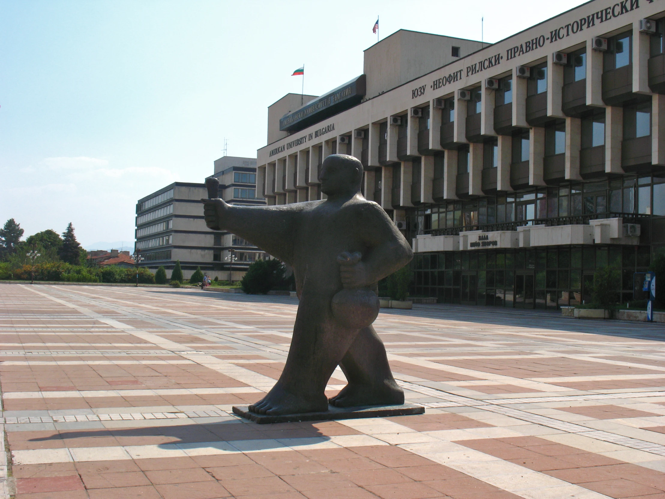 a sculpture is in front of a large building