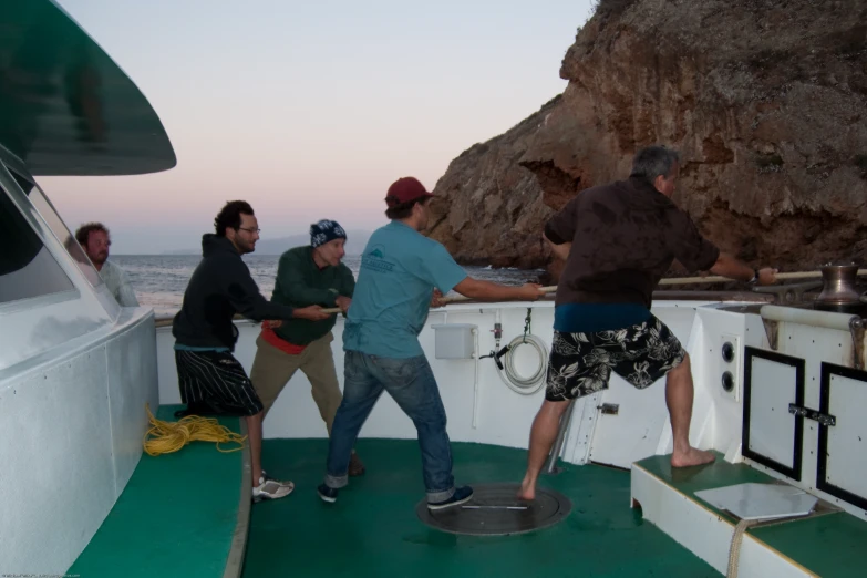 a group of men standing on a boat together