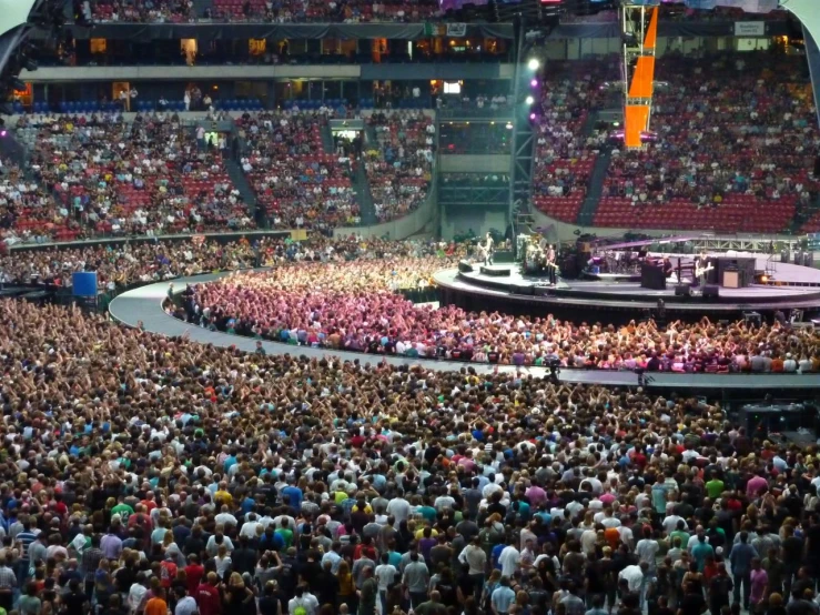 a large crowd watches a concert on stage