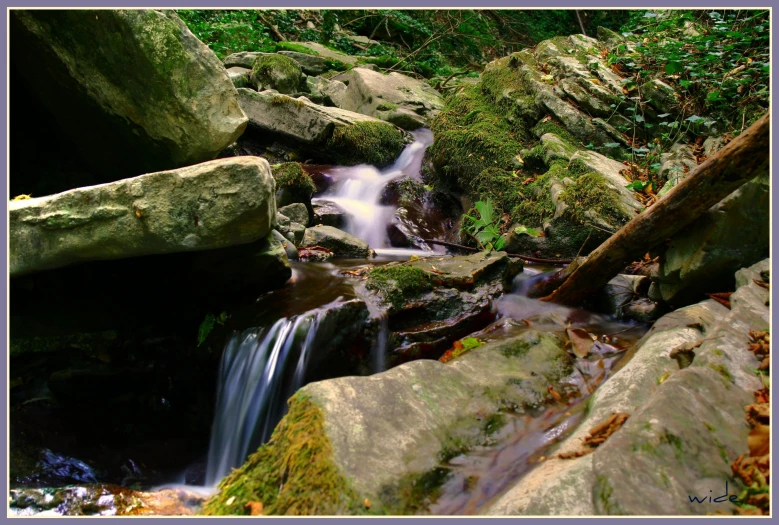 a group of rocks that are next to some water