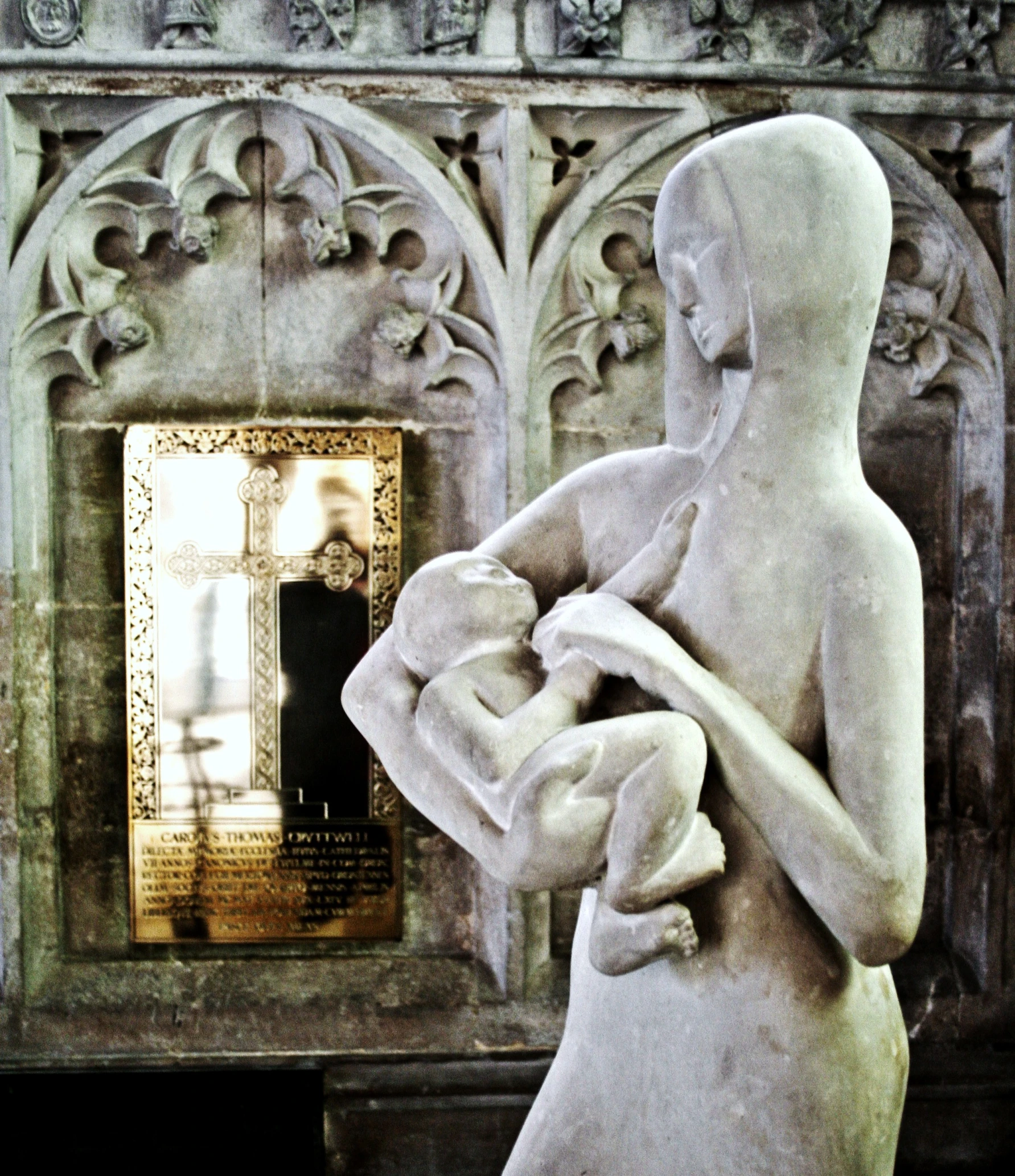 a statue in the shape of a woman holding a baby