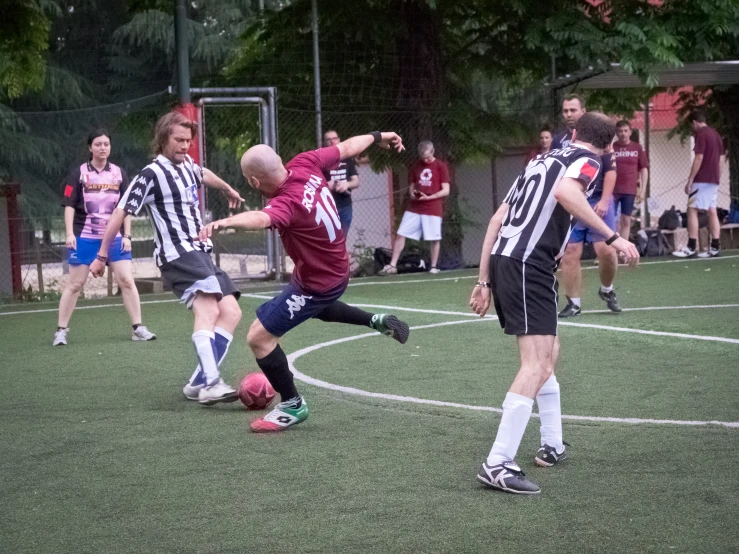 soccer players running and playing on the field