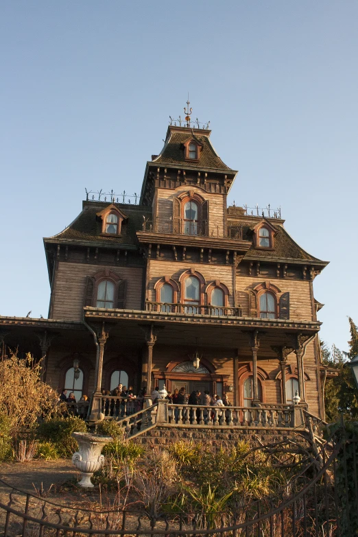 large wooden gothic style house with intricate trim and window frames