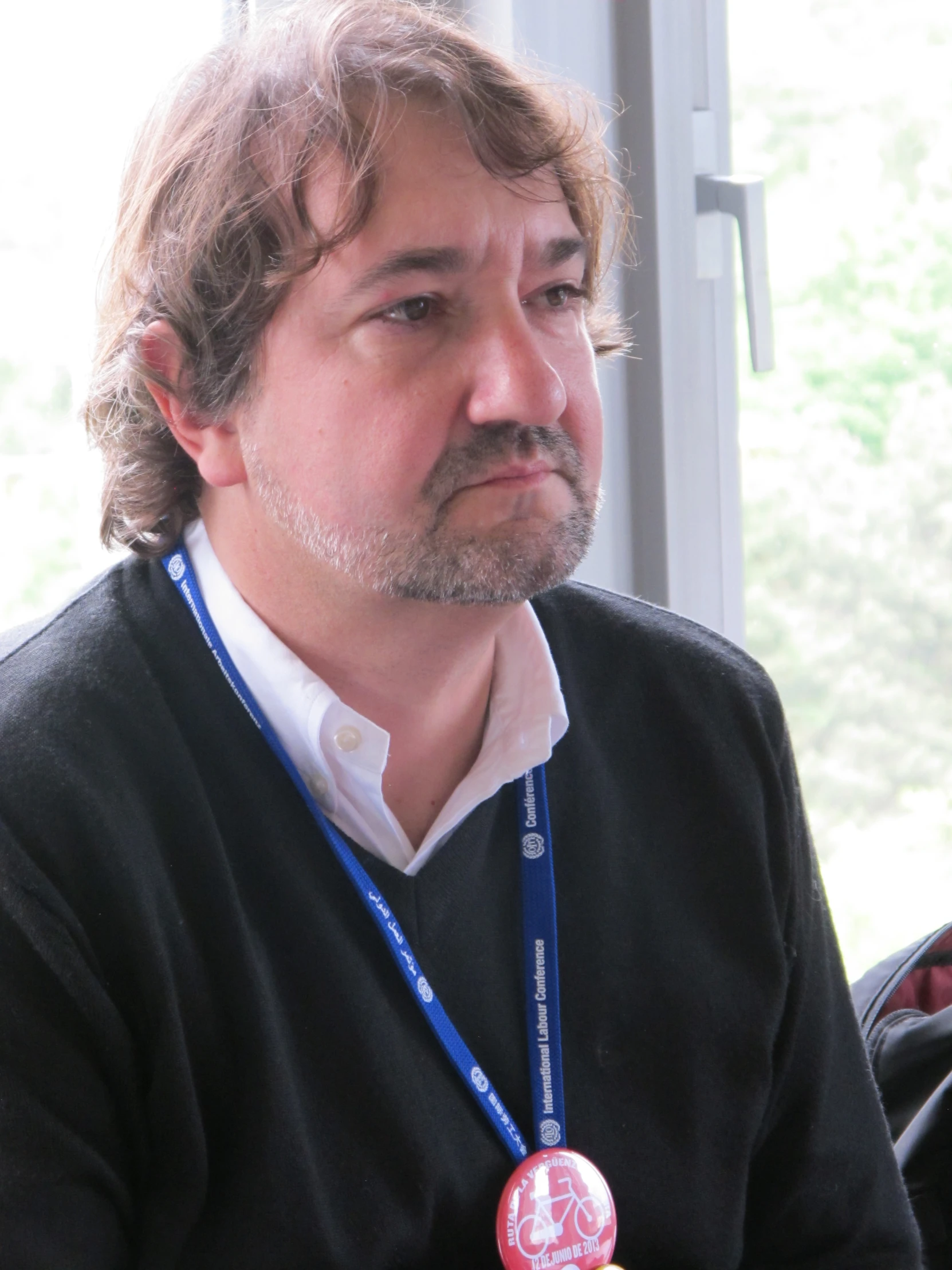 a man is sitting in front of a window