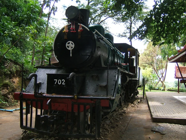 an old steam train is in the forest