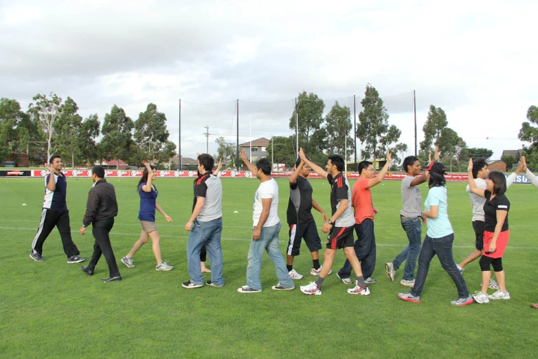 a group of people walking together across a field