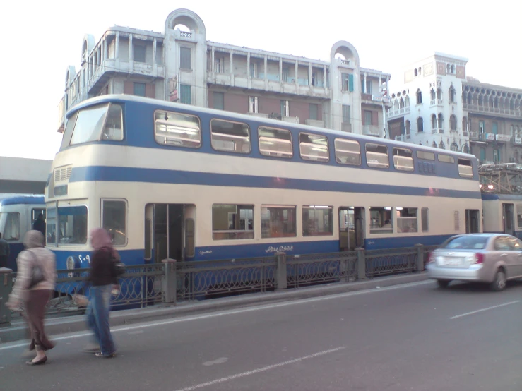 a large bus going down the road with other traffic