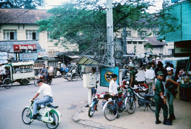 people ride bikes in the middle of a crowded street