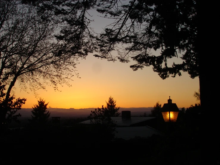 a sunset over a town in the distance