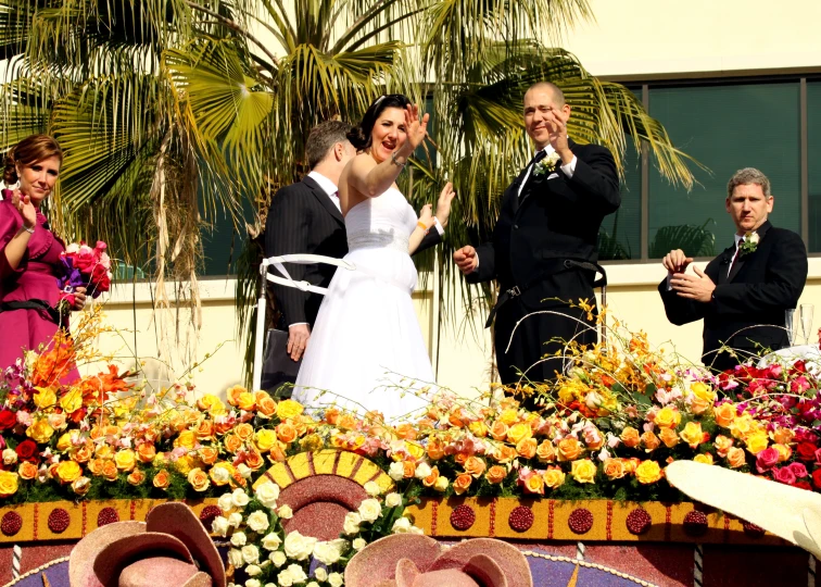 the bride and groom are standing in front of their wedding carriage